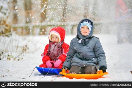 kids sit on sled