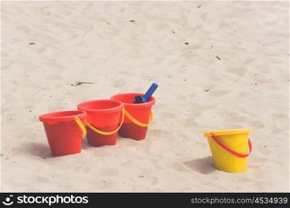 Kids toys in a sandbox in the summer