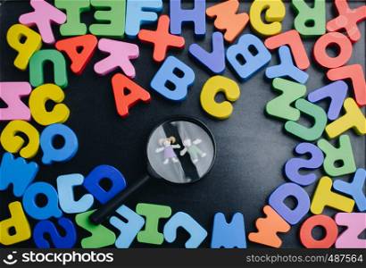 Kids under Magnifying glass and Colorful Letters of Alphabet