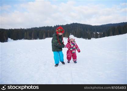 kids walking on snow at winter vacation in forest. happy children group have fun outdoor