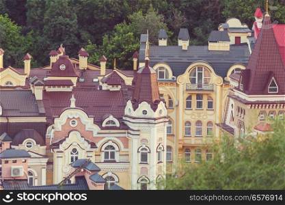 Kiev city. Old town. Ukraine. Beautiful view of the ancient street Andrew’s Descent and the St. Andrew’s Church among green trees of the Castle Hill in Kyiv