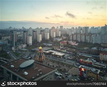 Kiev, Ukraine.- January 11,2018  View from a birdseye on the city of Kiev, modern high-rise buildings and a small church, a photo taken from a drone. Aerial view of the city of Kiev in the morning,