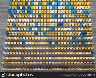 KIEV, UKRAINE - July 19, 2018. National Sports Complex Olimpiysky, aerial view from drone to a tribune with blue and yellow colors in a summer time before match.. KIEV, UKRAINE - July 19, 2018.Panoramic view from drone of tribunes with yellow and blue seats of National Sports Complex Olimpiysky on a summer day at sunset.