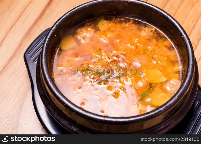 Kimchi soup in hot black iron pot, Korean traditional Kimchi Jjigae soup in bowl in the restaurant, Japanese hot pot food