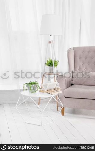 Kind of empty room, table and book, armchair. Kind of empty room, table and book