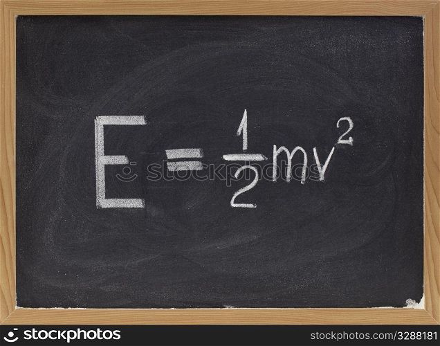 kinetic energy equation of classical Newtonian mechanics connecting it to mass and velocity of a point object - white chalk handwriting on blackboard