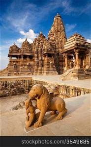 King and lion fight statue and Kandariya Mahadev temple. Khajuraho, India