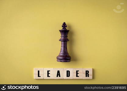 King in battle chess game stand on yellow background , leadership and business vision for a win in business game , Business leadership concept