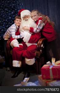 King Santa Clause giving Christmas Presents to Happy Children in the Christmas Night.