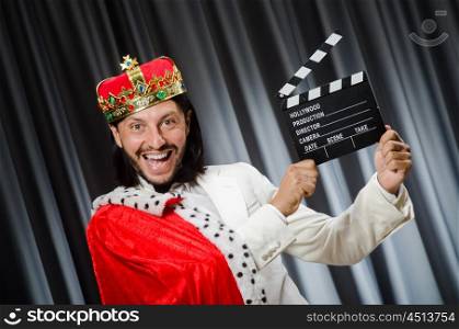 King with movie board in funny concept