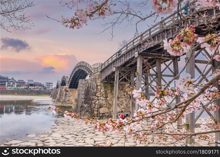 Kintaikyo Bridge in Iwakuni, Japan at sunset with cherry blossom