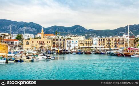 Kirenia historical city center, view to marina with many yachts and boats and mountains in the background, North Cyprus