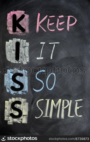 KISS acronym written in colorful chalk on a blackboard
