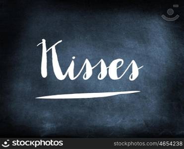 Kisses handwritten on a chalkboard