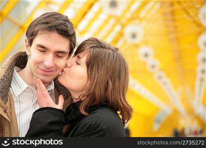 kissing couple on yellow bridge