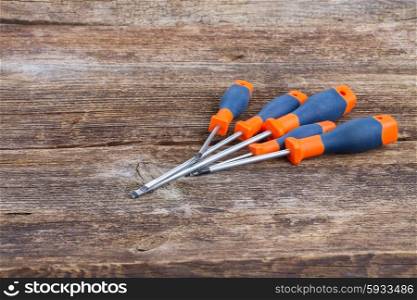 kit of screwdrivers on aged wooden background