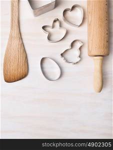 kitchen bake utensils with easter cookie cutters on white wooden background, top view,place for text