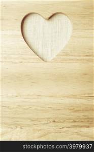 Kitchen board with heart shape as border frame background with space for text menu on wooden surface, empty blank sign
