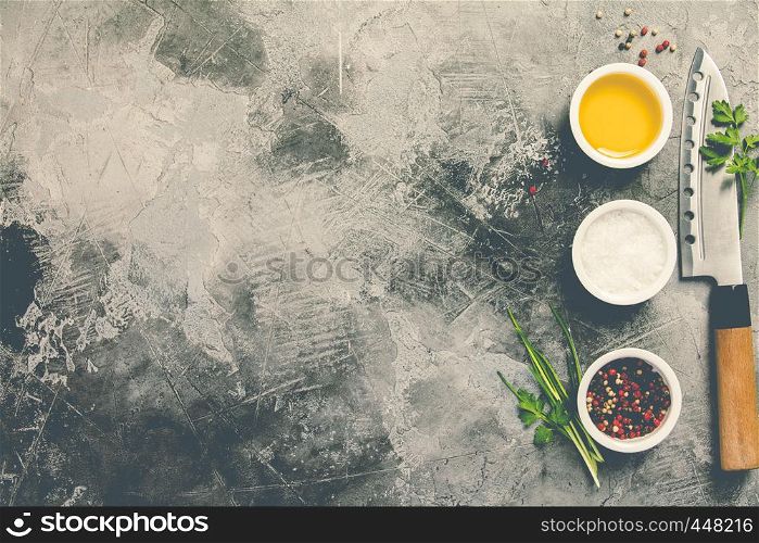 Kitchen knife and spices on grey stone background with space for text, top view. Cooking and asian food concept. Kitchen knife and spices , flat lay, top view