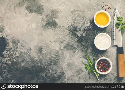 Kitchen knife and spices on grey stone background with space for text, top view. Cooking and asian food concept. Kitchen knife and spices , flat lay, top view