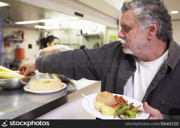 Kitchen Serving Food In Homeless Shelter