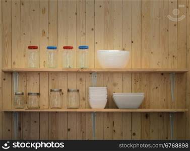 Kitchen shelving with bowls and jars on wooden wall background