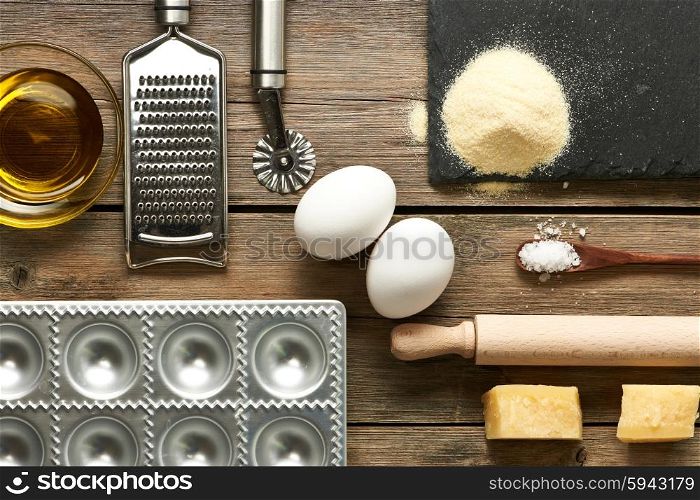 Kitchen utensils and ingredients for homemade pasta ravioli on wooden table