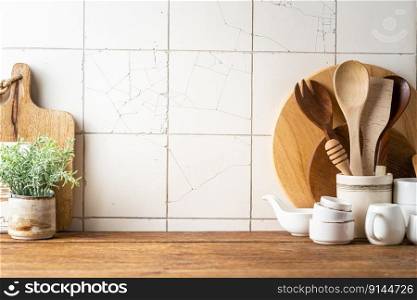 Kitchen utensils background with a blank space for a text and white tile background, home kitchen decor concept with kitchen tools, front view. Kitchen utensils background