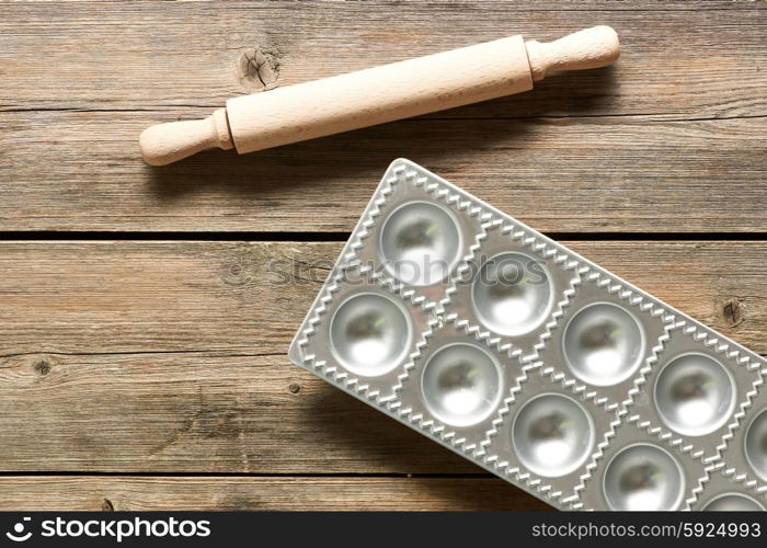 Kitchen utensils for homemade pasta ravioli on wooden table