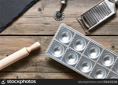Kitchen utensils for homemade pasta ravioli on wooden table