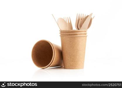 Kitchenware consisting of eco friendly disposable wooden cutlery and paper cup on white background. Wooden fork, knife and spoon in a paper cup. Zero waste concept.