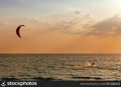 Kite surfer sailing in the sea at sunset ocean&#xA;