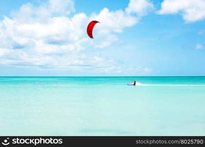 Kite surfer surfing on the Caribbean Sea at Aruba island