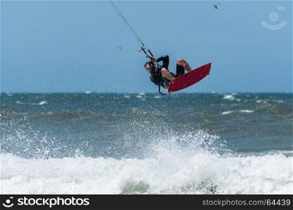 Kiteboarder enjoy surfing on a sunny day.