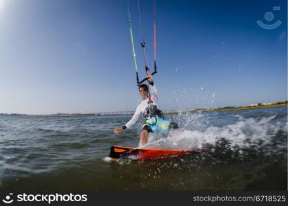 Kiteboarder enjoy surfing on a sunny day.