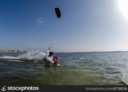 Kiteboarder enjoy surfing on a sunny day.