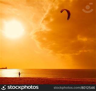 Kitesurfer at sunlight. Back view. Unrecognizable