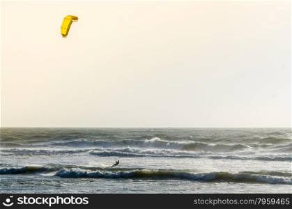Kitesurfer on a beautiful background of spray during the sunset.