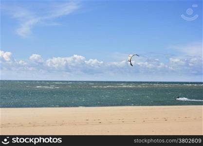 Kitesurfing. Kitesurfers rides the waves on high speed
