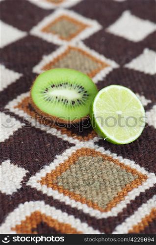 kiwi and lime on ethnic mat