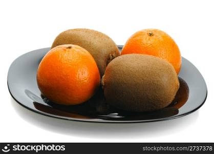 Kiwi and mandarin on a black plate on a white background