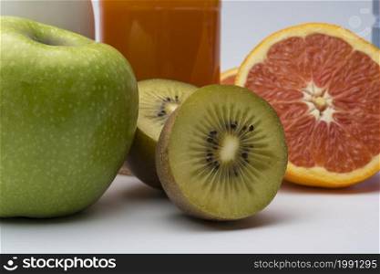 Kiwi, Apple and grapefruit on white background. The concept of diet, diet for weight loss.. Kiwi, Apple and grapefruit on white background.