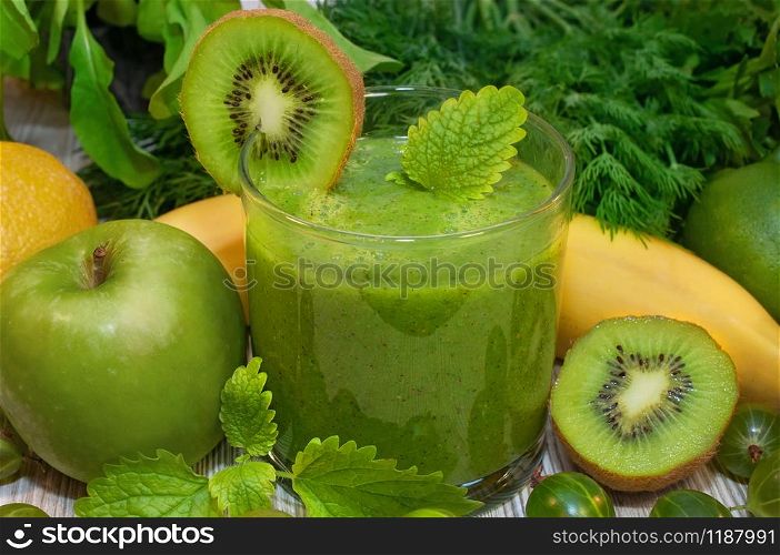 Kiwi, banana, apple and fresh greens smoothie for detox cleansing the body. Kiwi, banana, apple and fresh greens smoothie for detox cleansing