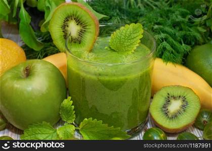 Kiwi, banana, apple and fresh greens smoothie for detox cleansing the body. Kiwi, banana, apple and fresh greens smoothie for detox cleansing
