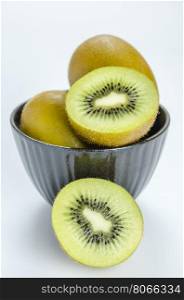 kiwi fruit and half with black bowl . kiwi fruit and half with black bowl on white background
