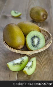 kiwi fruit and sliced with bamboo basket . kiwi fruit and sliced with bamboo basket on wooden background