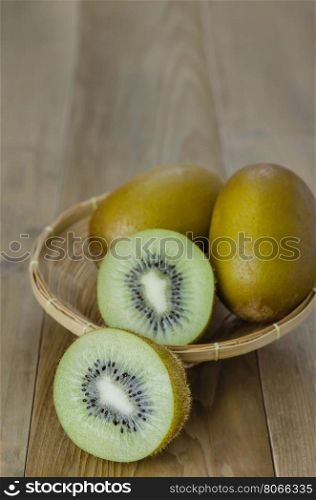 kiwi fruit and sliced with bamboo basket . kiwi fruit and sliced with bamboo basket on wooden background