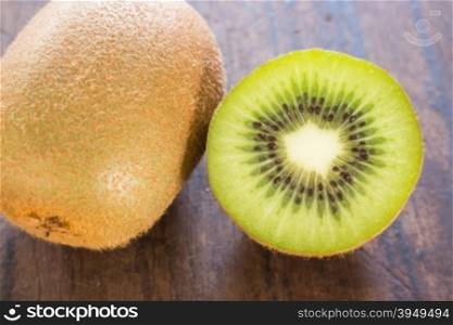 Kiwi fruit on brown wooden background, stock photo