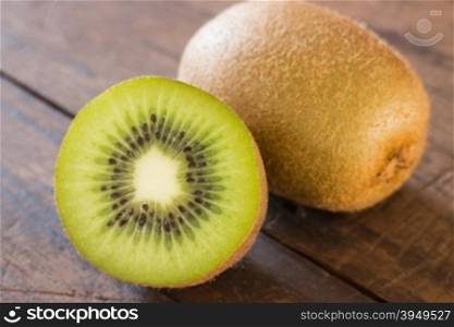 Kiwi fruit on brown wooden background, stock photo