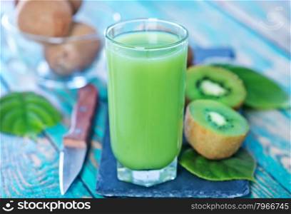 kiwi juice in glass and on a table